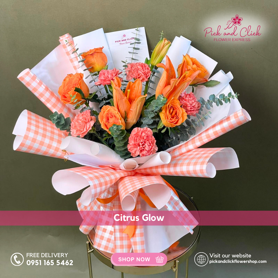 Bouquet of flowers with orange and pink flowers wrapped in checkered paper and ribbon, on a green background.