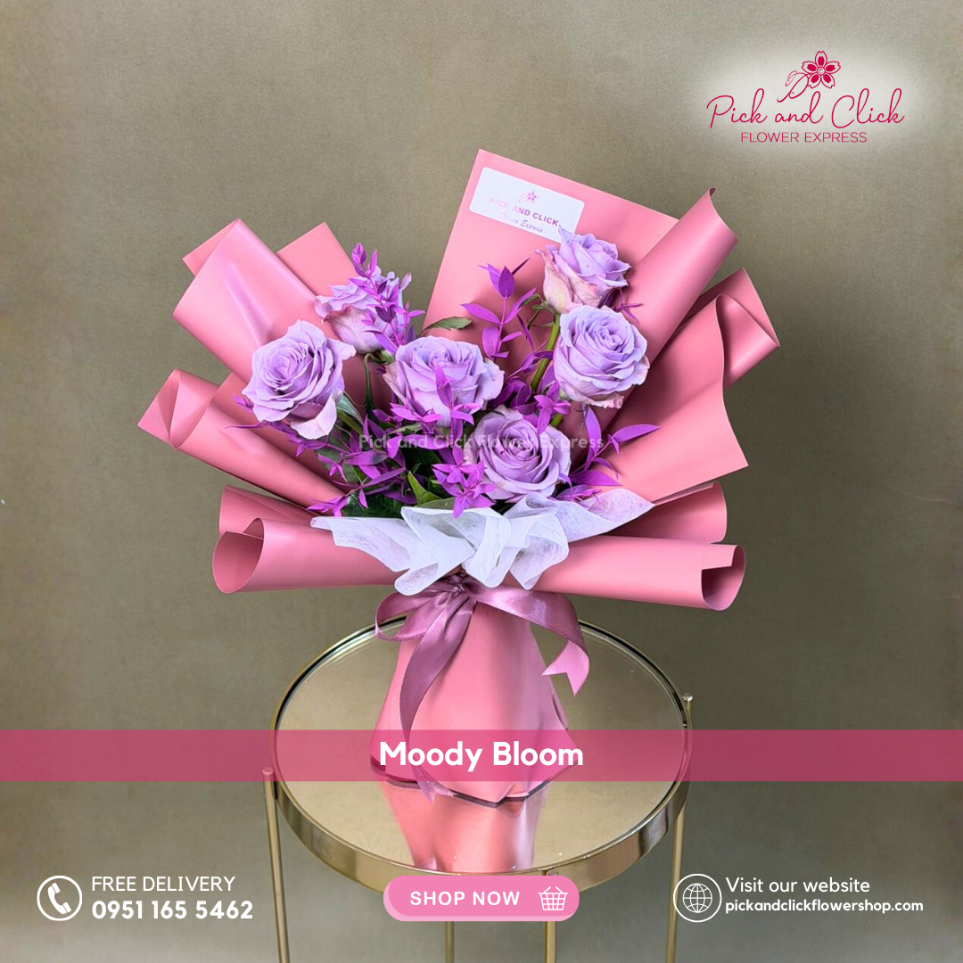 Moody Bloom bouquet featuring six Moody Blues roses accented with fresh parvi leaves in a modern premium hand bouquet.