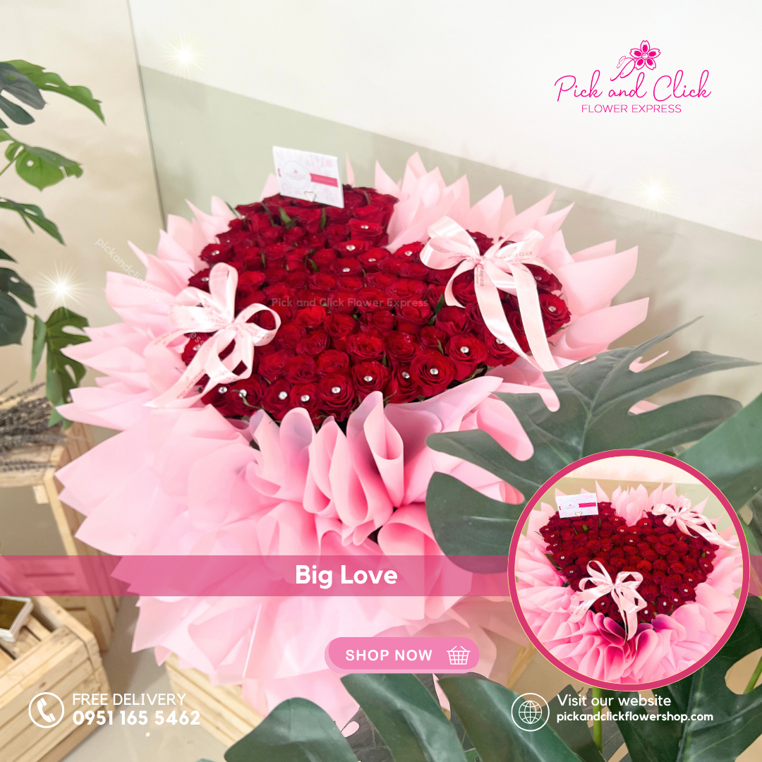 Heart-shaped bouquet of red roses with pink ribbons, displayed with green leaves and 'Pick and Click Flower Express' branding.