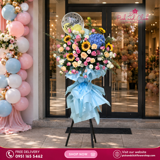 Blue Horizon Opening Stand featuring blue hydrangeas, sunflowers, peach and hot pink roses, white and pink lisianthus, fresh eucalyptus, and a bobo balloon, a vibrant and festive floral arrangement perfect for grand openings, celebrations, and special events in the Philippines.