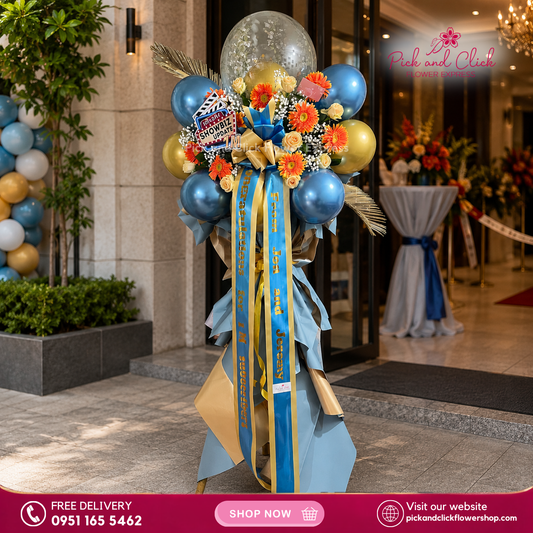 Blue Luck Flower Stand featuring imported roses, gerbera, dried palm leaves, gypsophila, balloons, and a custom printed ribbon, a vibrant and elegant floral arrangement perfect for grand openings, business launches, and special events in the Philippines.