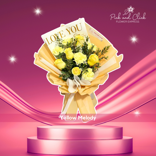 Bouquet of imported yellow roses, yellow carnations, and parvy leaves in yellow wrap and printed “I Love You” wrap — bright and loving gift