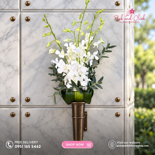 Columbary Arrangement 2 featuring white orchids accented with parvi leaves and fortune leaves, a serene and elegant floral arrangement designed for memorial visits, and respectful tributes in the Philippines.
