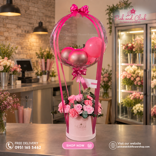 Emerald Dreams featuring Imported Light Pink Roses, Light Pink Carnations, and Eucalyptus in a box arrangement with a Bobo Balloon and Festive Balloons in the Philippines.
