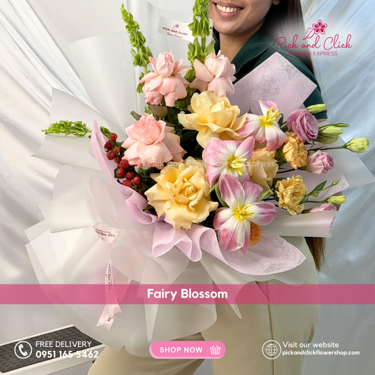Fairy Blossom Bouquet featuring imported roses, carnations, tulips, lisianthus, berries, and Bells of Ireland arranged in an elegant, whimsical hand bouquet for premium gifting.