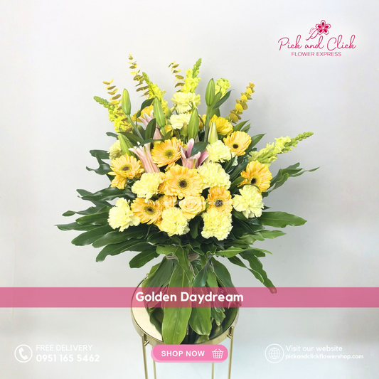 Golden Daydream Bouquet featuring yellow gerberas, yellow carnations, yellow spray roses, pink stargazers, snapdragons, eucalyptus, and lush greenery in an elegant hand bouquet, perfect for joyful celebrations and premium gifting.