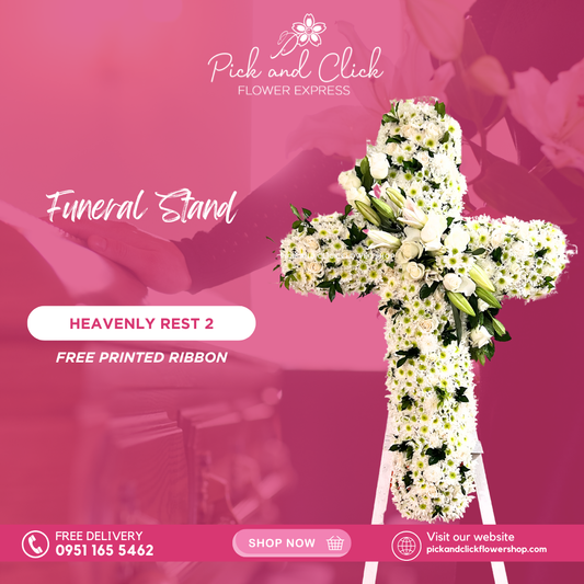 Cross-shaped funeral stand with white Radus, roses, and stargazers in an elegant white floral arrangement