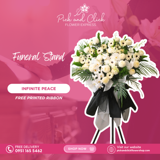 Infinite Peace Funeral Stand featuring pompons, white gerberas, orchids, and fresh green leaf fillers arranged in an elegant standing floral tribute for sympathy and remembrance.