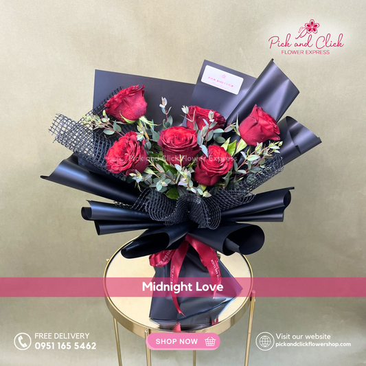 Midnight Love Bouquet featuring six imported red roses accented with fresh parvi leaves in an elegant premium hand bouquet.