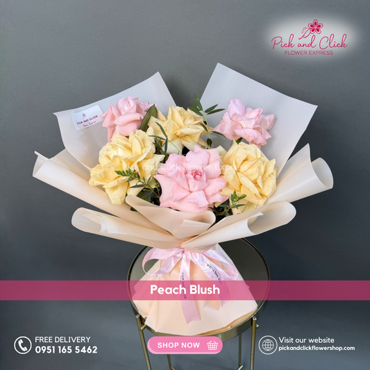Peach Blush bouquet featuring imported light pink and peach roses with parvi leaves arranged in a soft romantic mini bouquet.