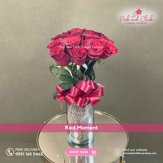 Red Moment vase arrangement featuring 12 imported red roses arranged in an elegant glass vase for romantic occasions.