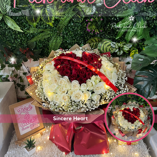 Heart-shaped bouquet of imported white and red China roses in two-tone printed wrap