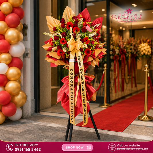 Ruby Luck Opening Stand featuring red roses, red gerbera, golden rod, and gold sprayed eucalyptus, a bold and luxurious floral arrangement designed to symbolize prosperity and celebrate grand openings, business launches, and special events in the Philippines.