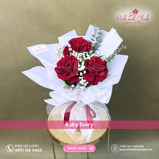 Ruby Ivory Bouquet featuring three imported red roses accented with gypsophila and fresh eucalyptus in an elegant mini hand bouquet.