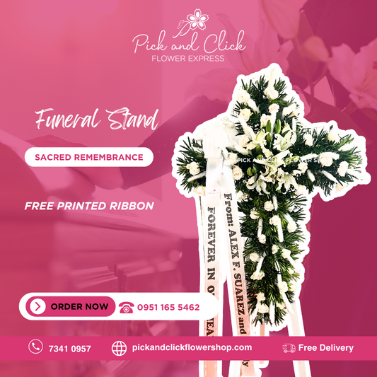 Cross-shaped funeral stand with white roses, podocarpus greenery, and pampas grass for a serene and elegant memorial tribute