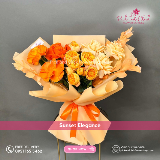 Sunset Elegance bouquet featuring orange and peach roses, yellow spray roses, and melaleuca arranged in a warm elegant hand bouquet.