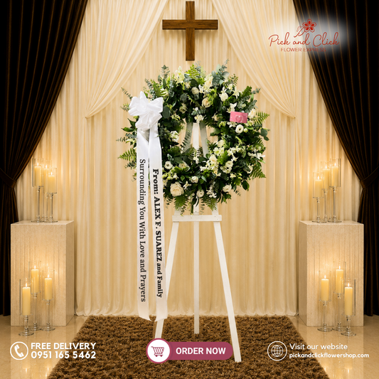Surrounded Comfort Funeral Stand featuring white roses, orchids, Pako leaves, eucalyptus, and silver dollar leaves in an elegant white and green funeral flower arrangement for sympathy, memorial services, and funeral ceremonies in Metro Manila, Philippines.