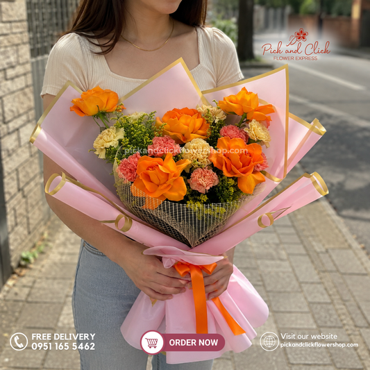 Tropical Bloom Bouquet featuring 5 Orange Roses, 5 Orange Carnations, 5 Champagne Carnations, and Golden Rod in a vibrant orange and champagne flower bouquet in the Philippines.