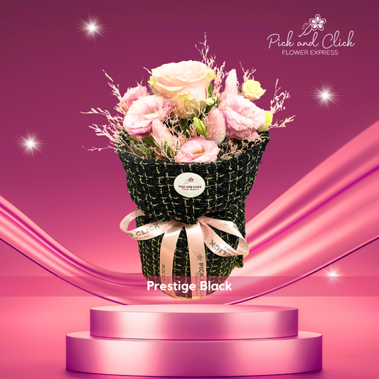 Bouquet of Ecuadorian rose, pink lisianthus, tulips, and misty pink in black cloth wrap — modern and romantic floral gift
