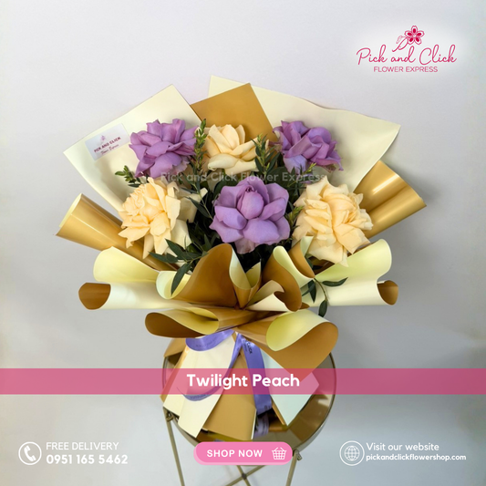 Twilight Peach bouquet featuring moody blues and peach roses with parvi leaves arranged in a petite modern floral bouquet.